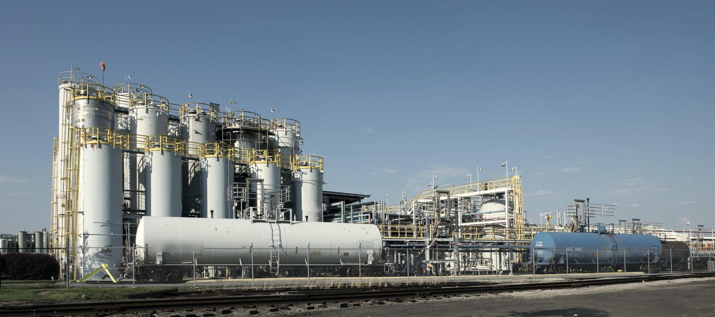 Vertical storage tanks and rail tank cars at a bulk liquids facility
